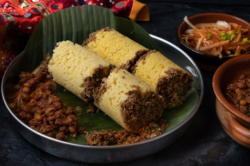 Traditional cholam puttu- Kerala steamed corn cakes served with kadala curry and other side dishes