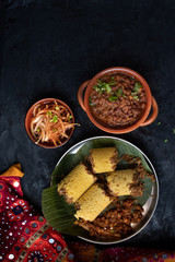 Traditional cholam puttu- Kerala steamed corn cakes served with kadala curry and other side dishes