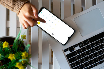 Hand using mobile calculator in the office.
