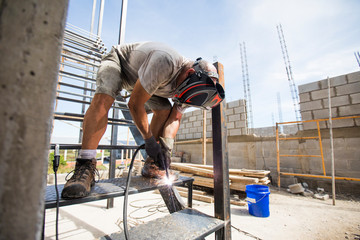 Worker welding at construction site