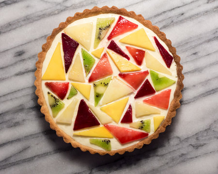 Abstract Fruit Tart with Mango, Kiwi, Plum, and Peach