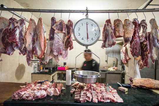 Meat and weigh scale hanging in a butcher stall
