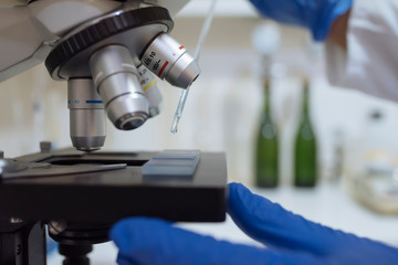 Close up of sample on microscope in winery laboratory.