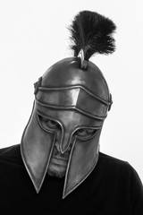 Man in historical copy helmet Spartan warrior on a white background