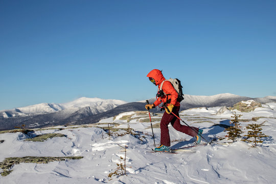 Backcountry skier skins across summit of Baldface, NH Mount Washington