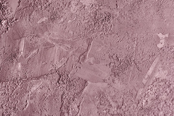 Abstract concrete background with a dirty burgundy hue. Photo with a texture of uneven plaster