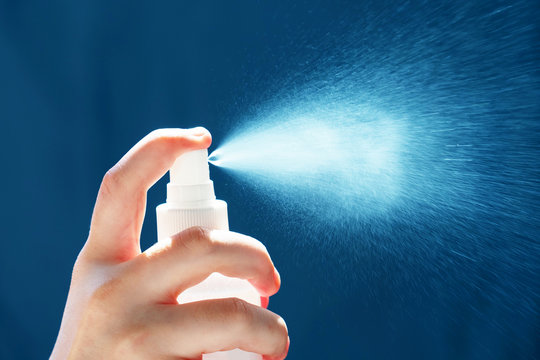 Woman disinfects. Hand of woman is spraying antiseptic, disinfector, prevent infection of covid virus, contamination of germs or bacteria, coronavirus