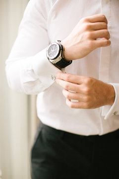 Groom's wristwatch and cufflinks. Suit.
