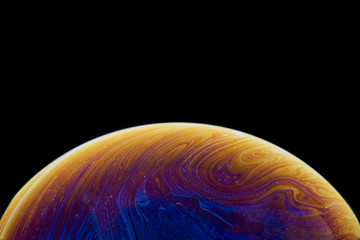 Burbuja de jabón simulando la atmosfera de un planeta con diferentes formas, colores y el fondo negro © Edgar1 BJ