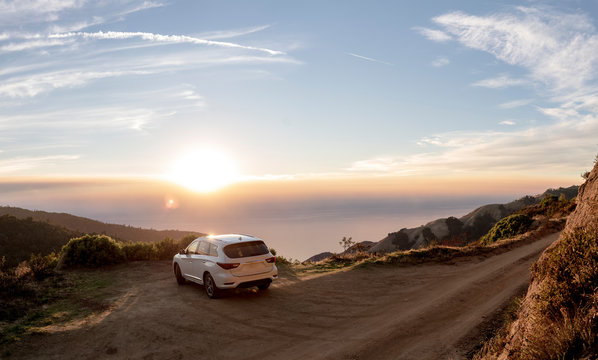 Car parked along dirt road  overlooking Big Sur coastline