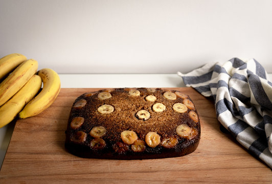 View of a homemade banana bread with diced bananas over a wooden table