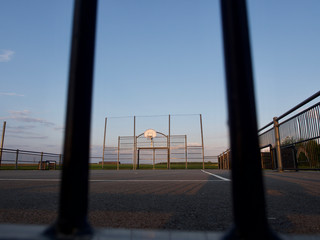 basketball court in the background of the setting sun, top view, free space for inscriptions, sad view of empty basketball courts © KRIS-ART