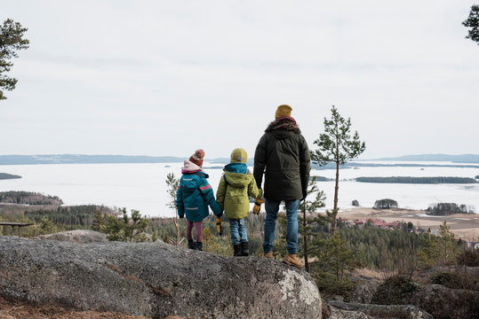 father and his kids enjoying a beautiful coastal view in Sweden