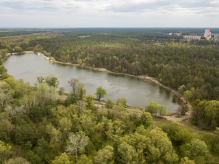 Fototapeta na wymiar Forest lake on a spring day. Aerial drone view.