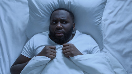 Nervous man seeing bad dream during sleeping, cant waking up, stressful life