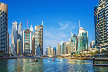 Dubai Marina canal with azure water and high rise buildings, United Arab Emirates.