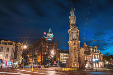 Munt Tower or Munttoren in Amsterdam historical center, night city, Netherlands.