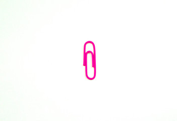 Pink paper clip isolated on a white background.