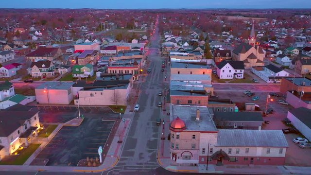 Aerial flyover of peaceful small town USA at morning twilight, empty streets amid the Covid-19 pandemic of 2020.