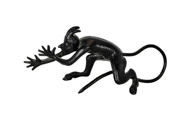 Cast-iron statuette of devil isolate on a white background close-up.