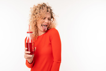 Beautiful caucasian woman drinks red juice