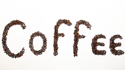 
The word coffee, written with roasted coffee beans, on a white background
