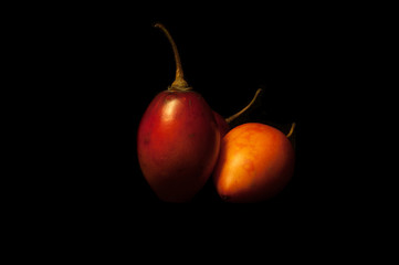 Some tomatoes on black background