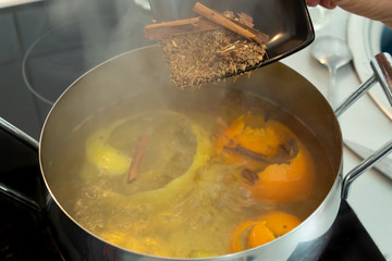 Adding ingredients to a boiling pot to cook syrup for French toast