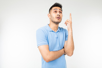 Fototapeta premium man with a blue shirt thinking about an idea on a white isolated background