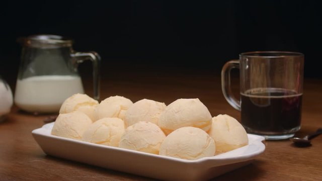 Brazilian cheese bread. Breakfast table with cheese bread, coffee, sugar and cake