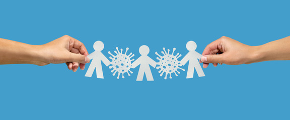 hands holding paper chain people with coronavirus over blue background
