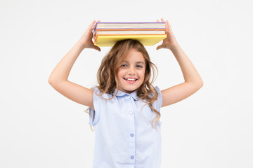 girl schoolgirl with a mountain of books for knowledge isolated on white background with copy space