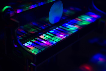 Piano on a dark background in the light of lamps. Close-up. Background.