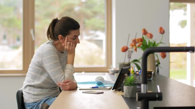 remote job, business and people concept - sick and tired young woman with tablet pc computer working at home office and coughing