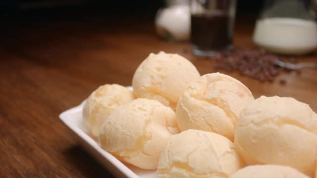 Brazilian cheese bread. Breakfast table with cheese bread, coffee, sugar and cake
