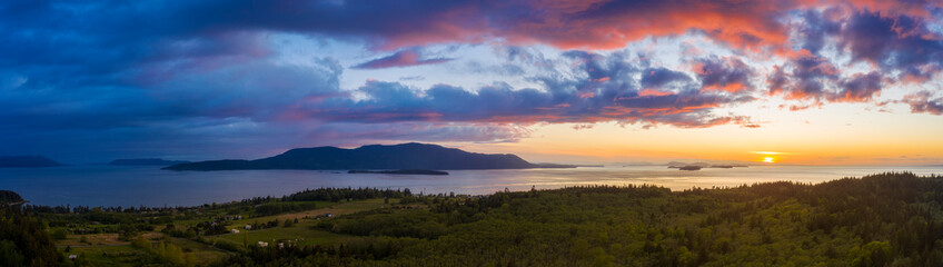 Dramatic Aerial Sunset View of Orcas Island, Washington. Drone aerial shot of Orcas Island located in the San Juan Islands and surrounded by the Salish Sea. Viewed from Lummi Island in the foreground.