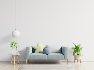 Empty living room with blue sofa, plants and table on empty white wall background.