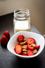 Cereals with strawberries and milk as breakfast