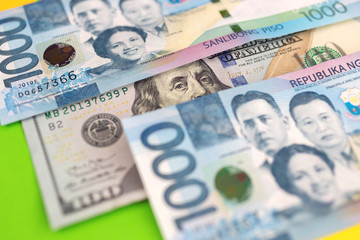 Close up of cash banknote of one thousand Philippines peso and us dollar, macro