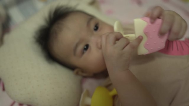 Baby boy using soothing teether 