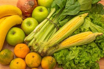 set of fresh vegetables and fruits. Healthy food, natural life. Corn, onion, chard, lettuce, tangerines, apples and bananas.