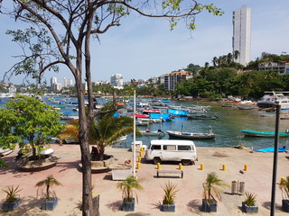 View of the fisherman's walk, with a van and several boats on Manzanillo beach