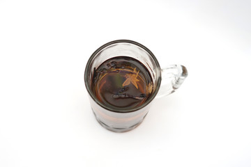 Big glass of hot brew tea top view isolated on white