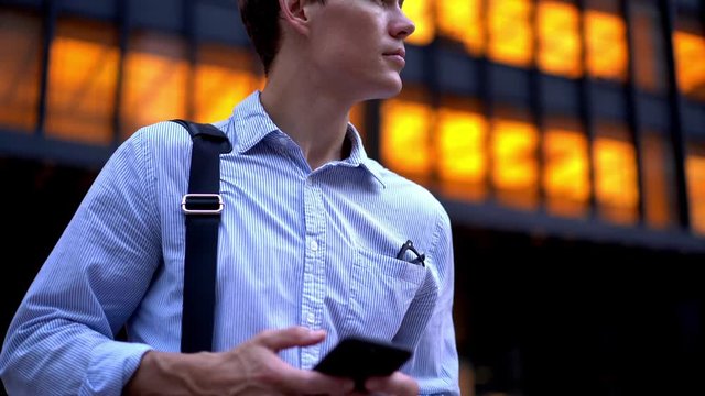 Handsome man in formal wear text sms message while tracking pgs for order taxi in financial district waving on street, executive manager search banking information on smartphone device
