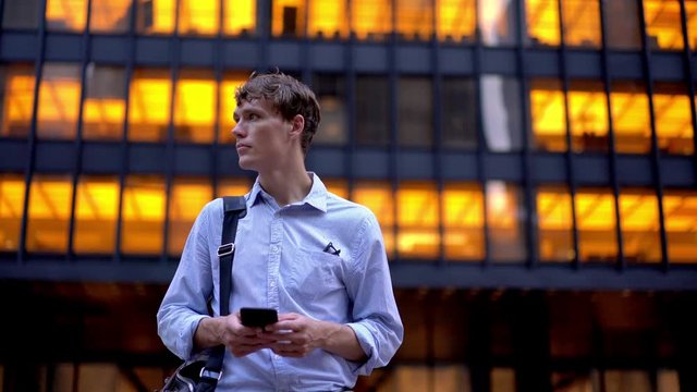 Intelligent man with briefcase text sms message while tracking pgs for order taxi in financial district waving on street, executive manager search banking information on smartphone device
