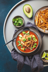 Mexican style table with spicy aztec soup with fried tortilla. Sopa azteca
