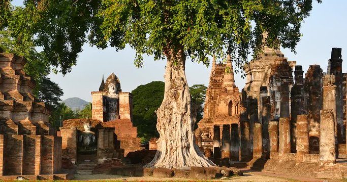 4k Mahathat temple in Sukhothai historical park; Thailand.Seated Buddha(Phra Atchana) at Wat Si Chum temple in Sukhothai Historical Park; a UNESCO world heritage site; Thailand. 