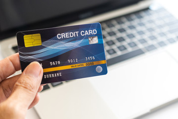 Man holding credit card on laptop. On-line shopping on the internet using a laptop