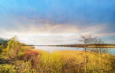 Fototapeta na wymiar Panoramic colorful view of lake on sunset in spring