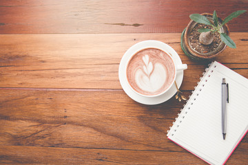 Latte art coffee on wood table with space for text. Top view.